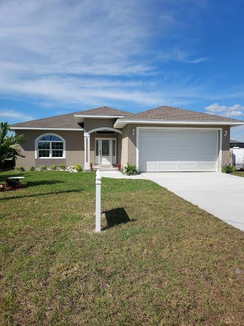 a front view of a house with a yard and garage