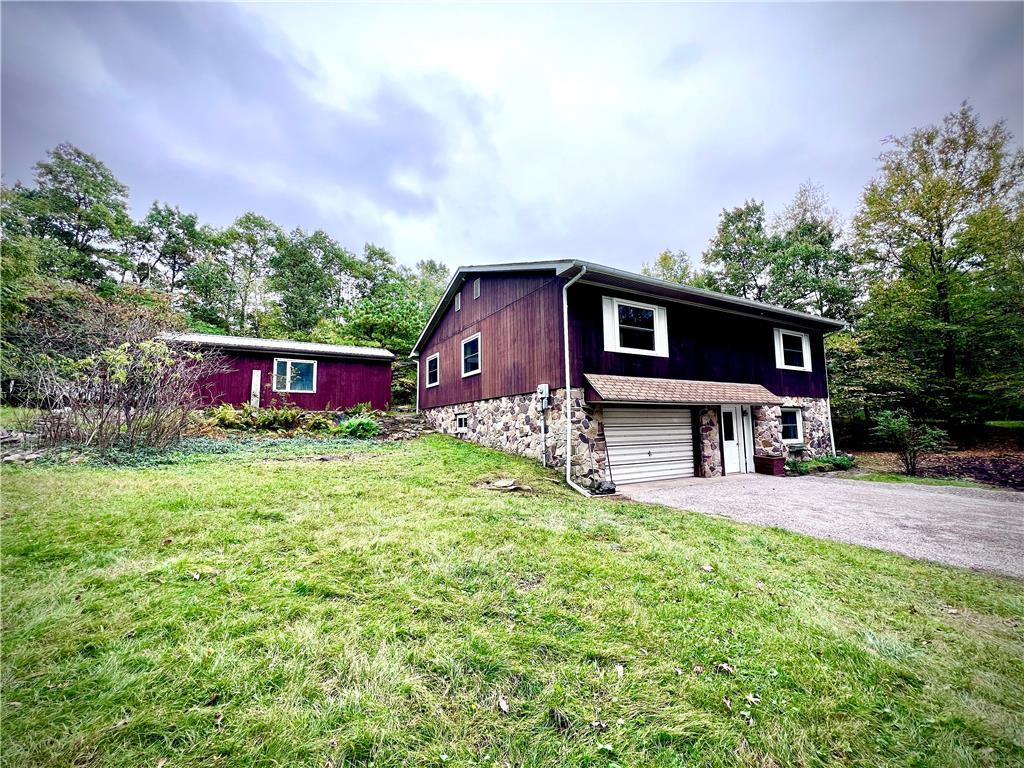 a house view with a sitting space and garden