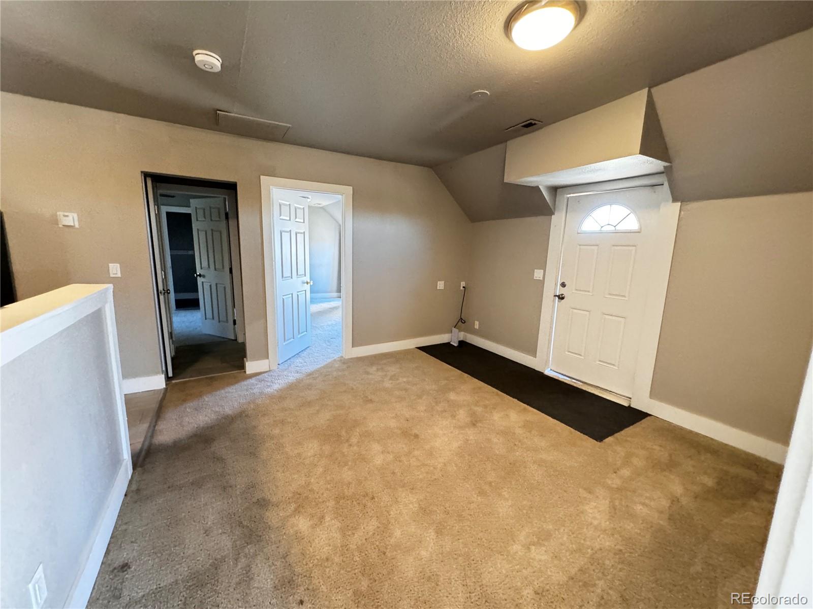 a view of a livingroom with a dishwasher and a refrigerator