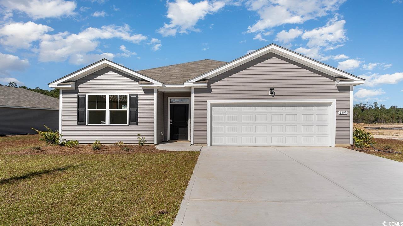 Single story home featuring a front lawn and a gar