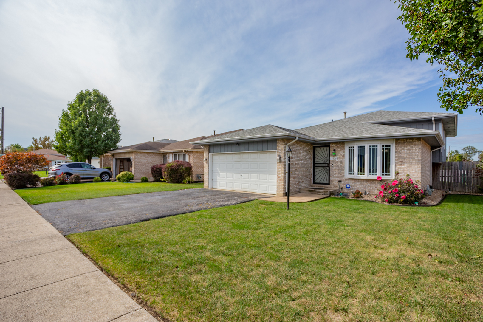 a front view of house with yard and green space