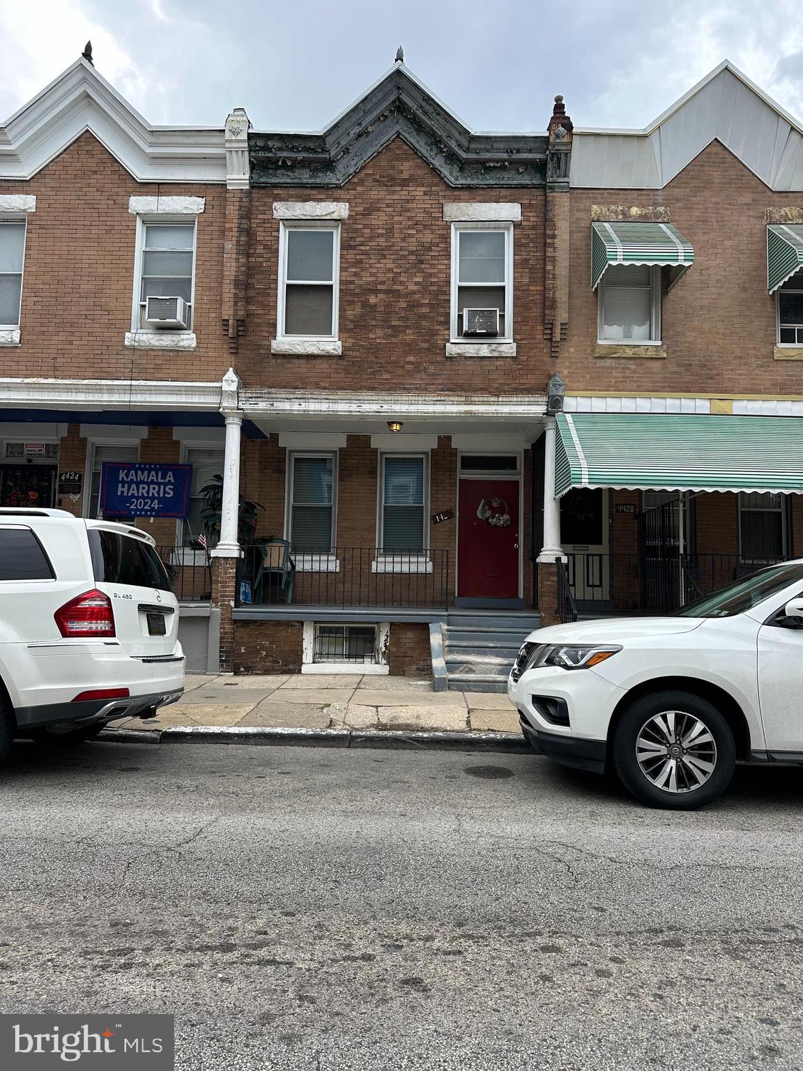 a car parked in front of a big house