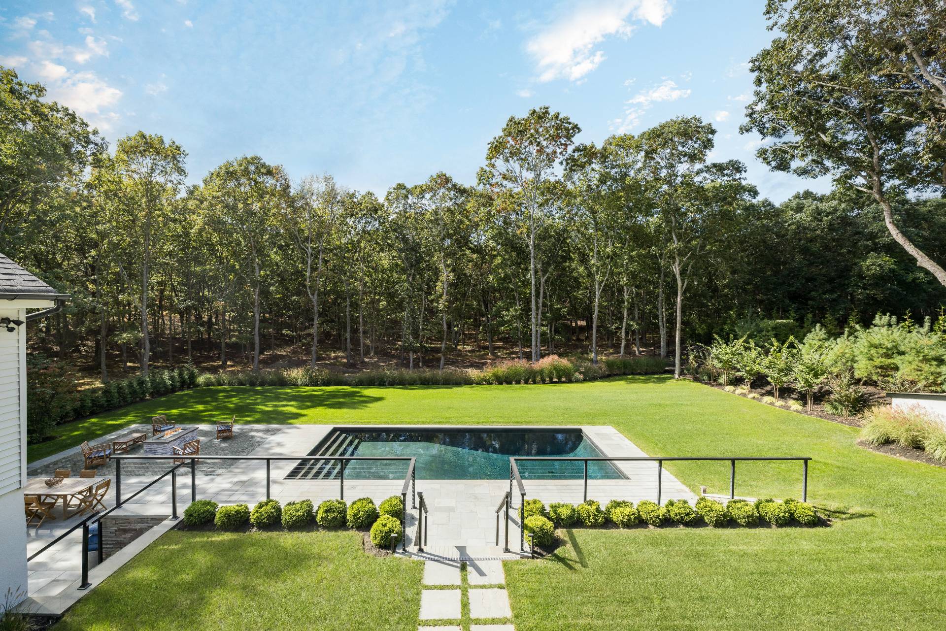 a view of a big yard with table and chairs