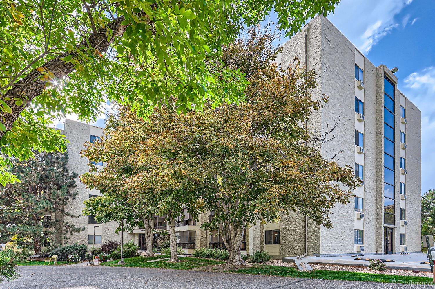 a front view of a building with trees