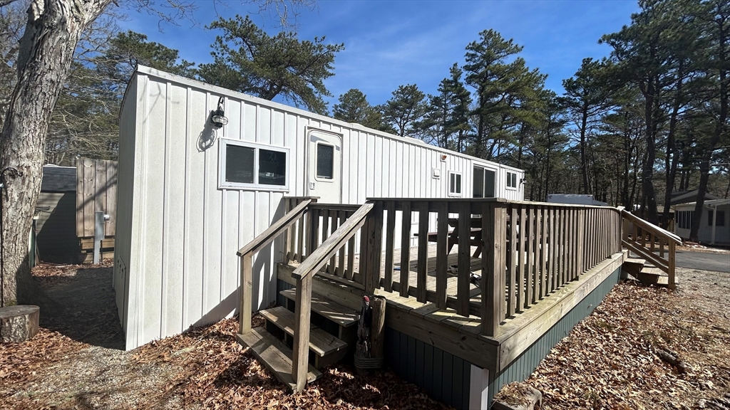 a view of a house with backyard and deck