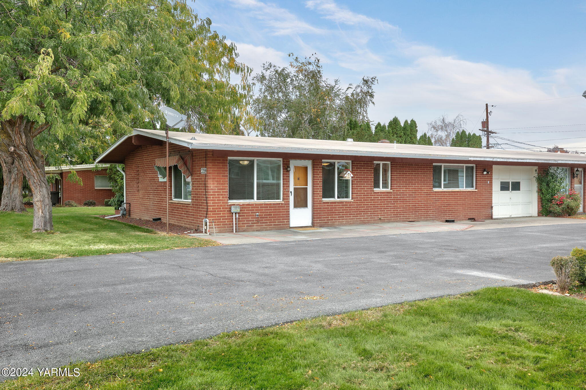 a front view of house with yard and green space