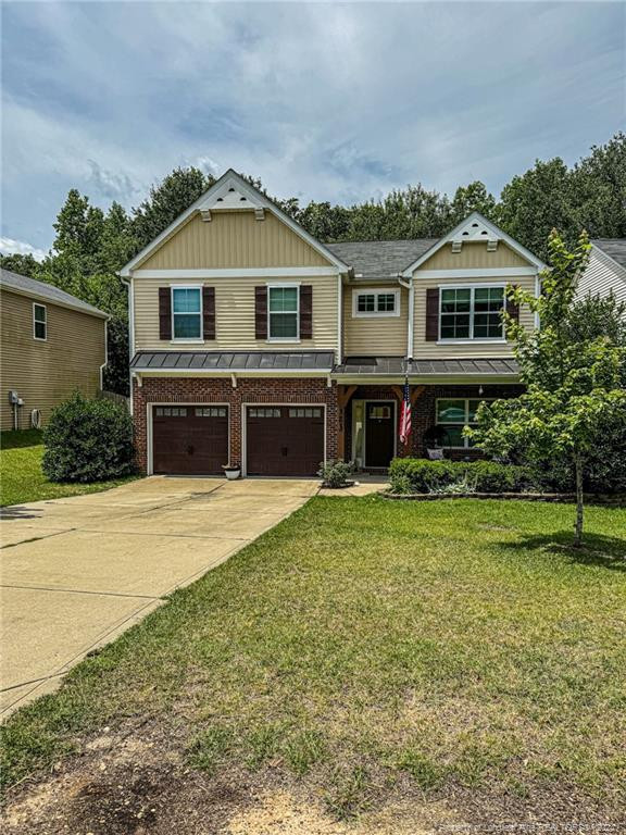 a front view of house with yard and green space