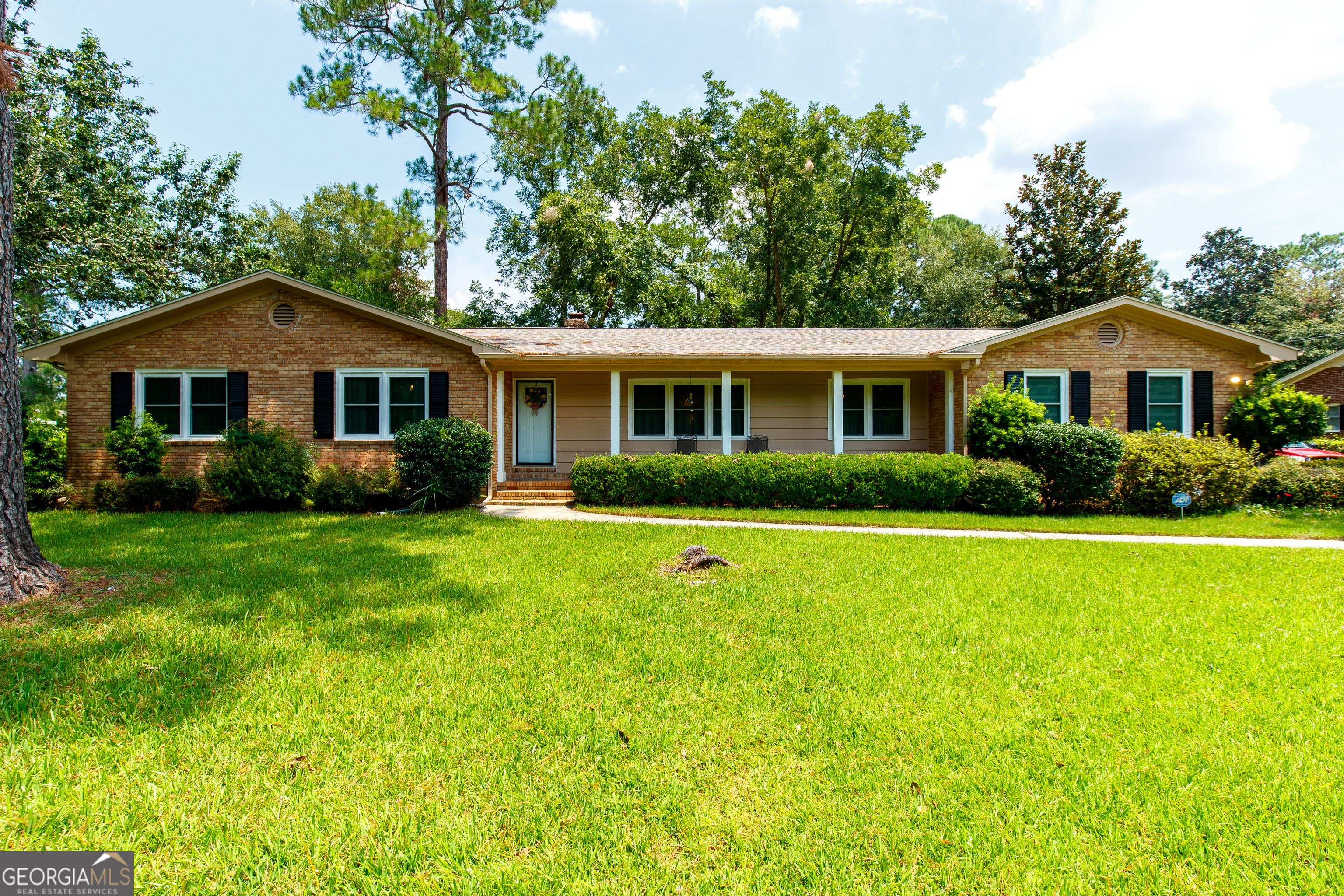 a front view of house with yard and green space