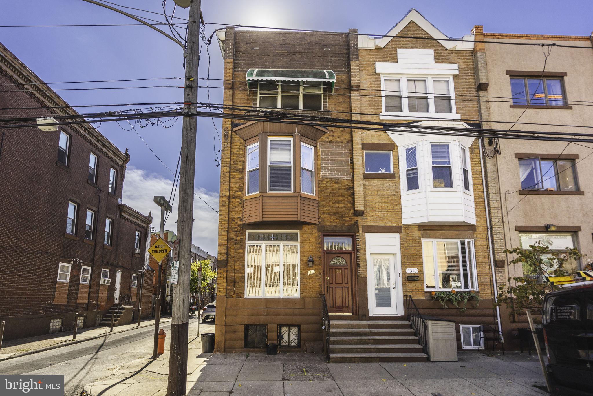 a front view of a residential apartment building with a yard