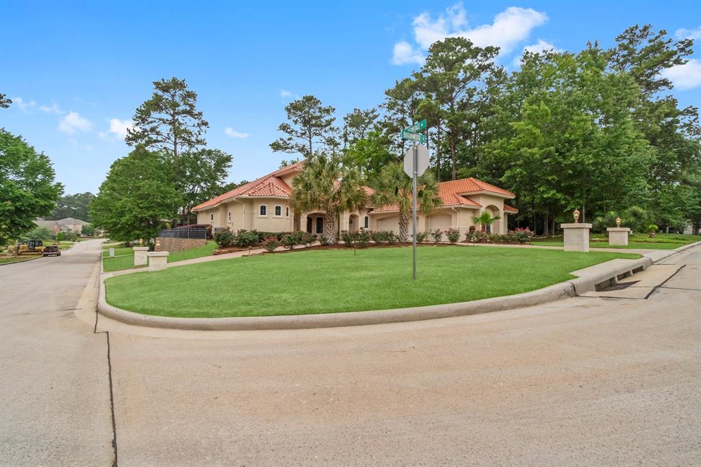 a white house with a yard and plants