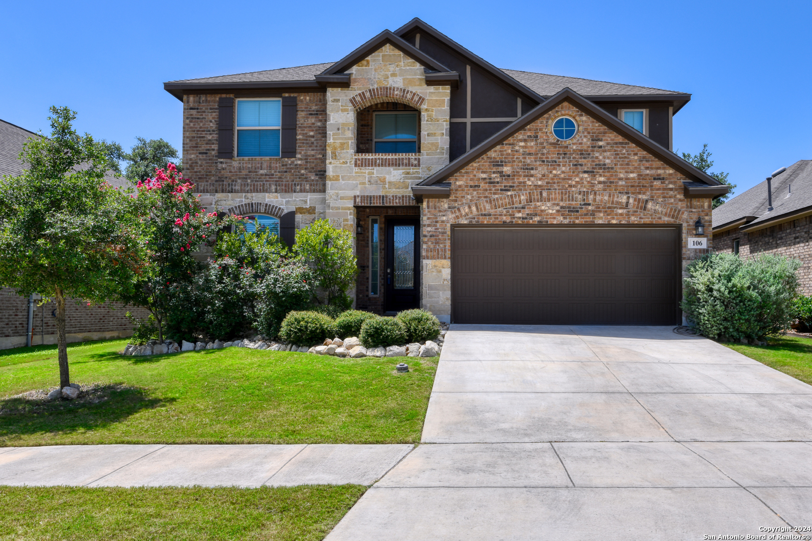 a front view of a house with a yard