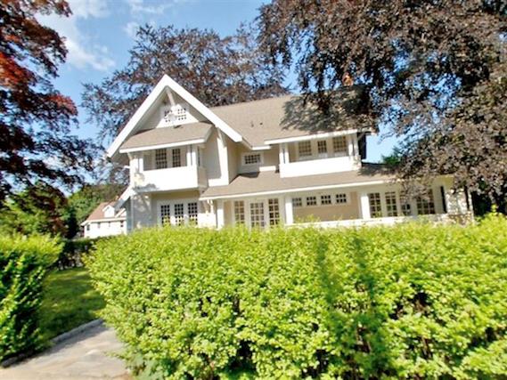 a front view of a house with a garden