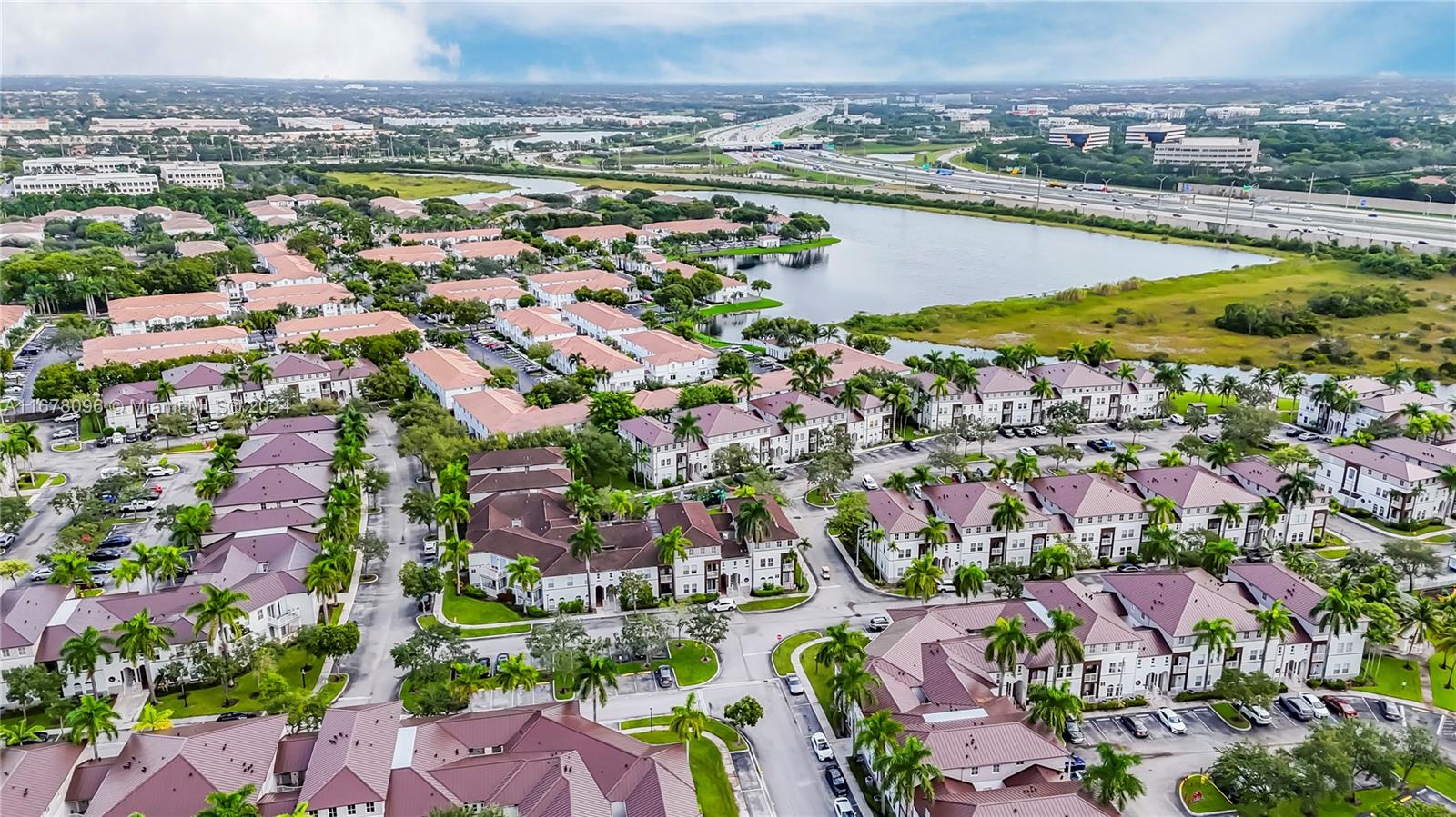 an aerial view of residential building with outdoor space swimming pool and ocean view