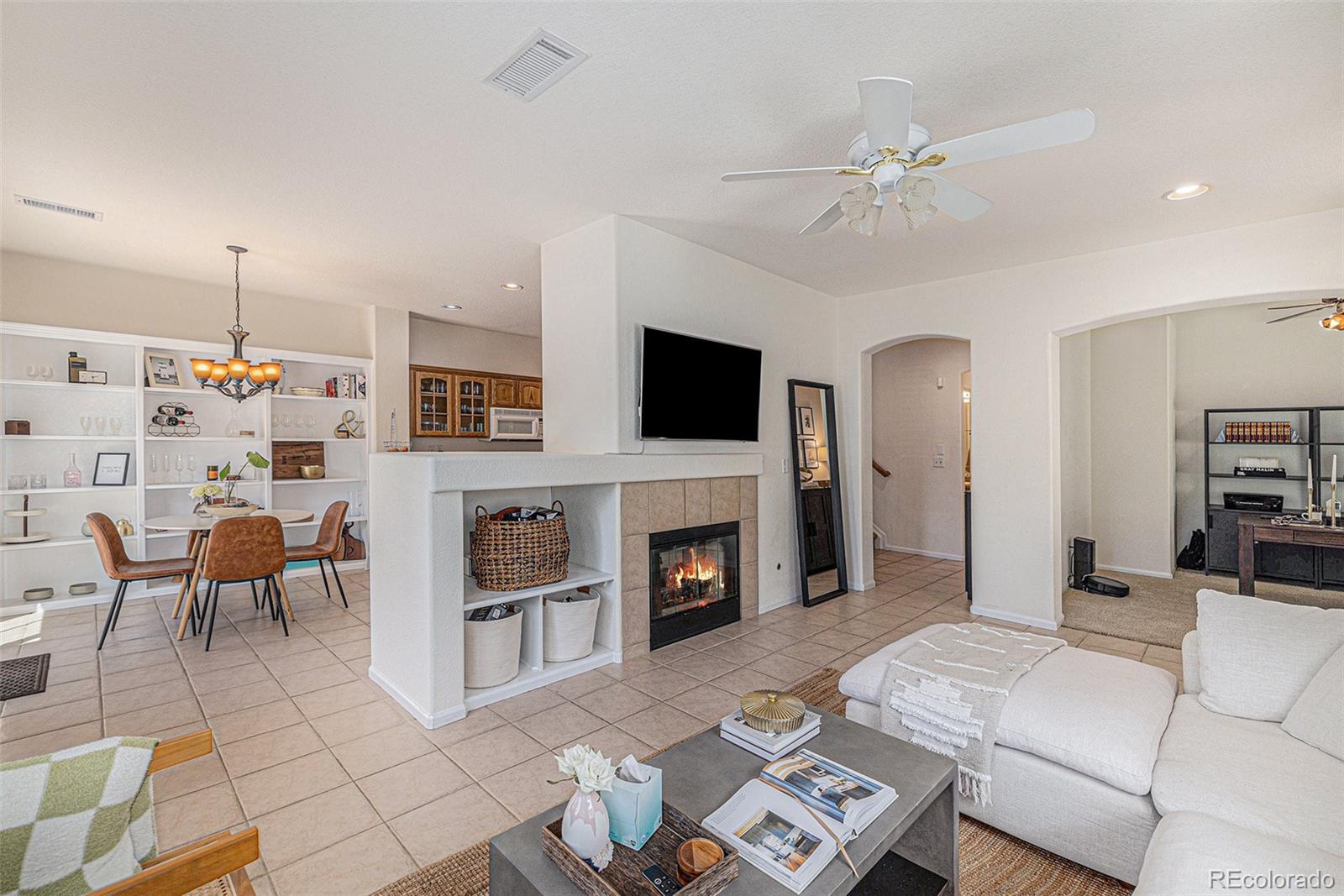 a living room with furniture a fireplace and a flat screen tv