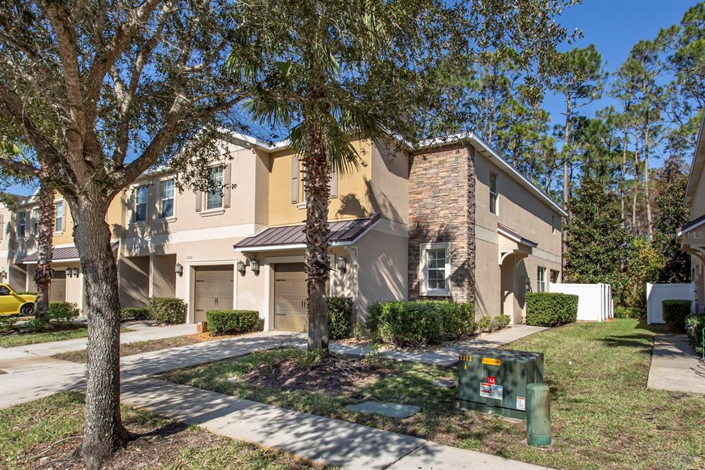 a front view of a house with garden