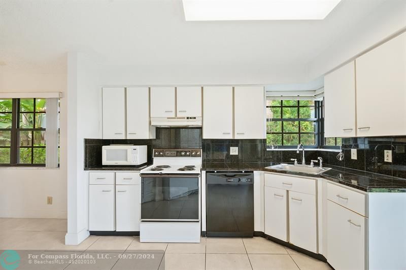 a kitchen with a sink stove and cabinets