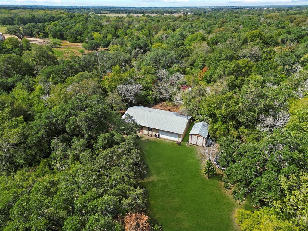 an aerial view of a house with a yard