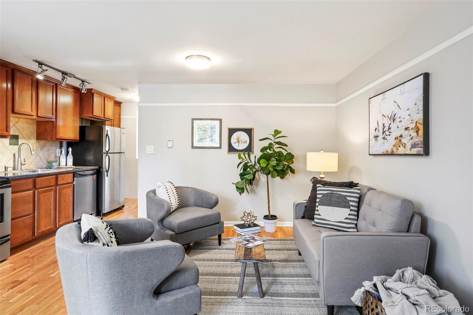 a living room with furniture and a potted plant