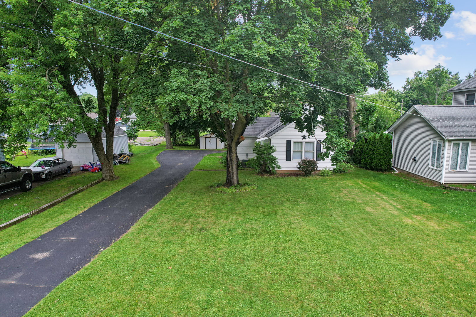 a view of house with backyard and garden