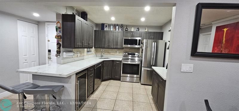 a kitchen with stainless steel appliances a sink stove and refrigerator