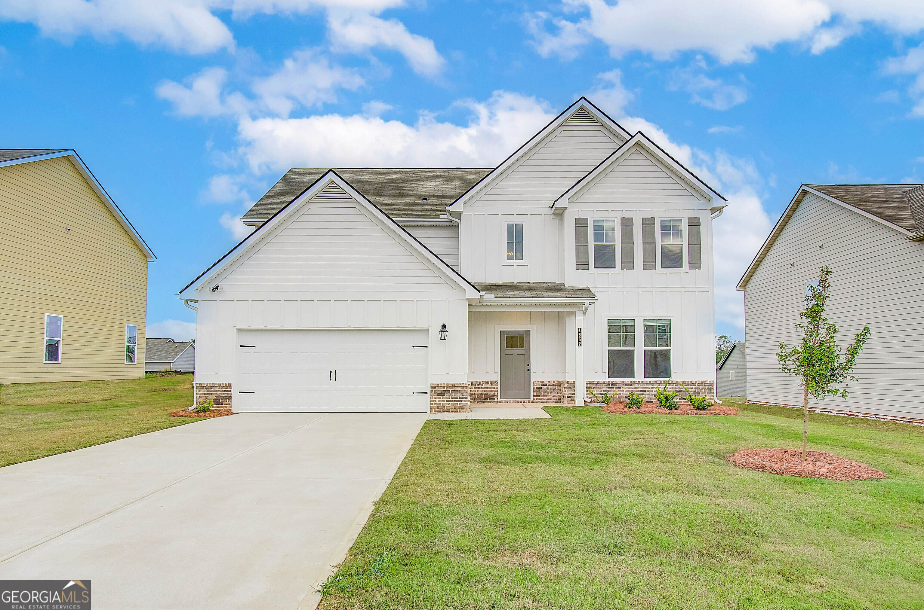 a front view of a house with a yard