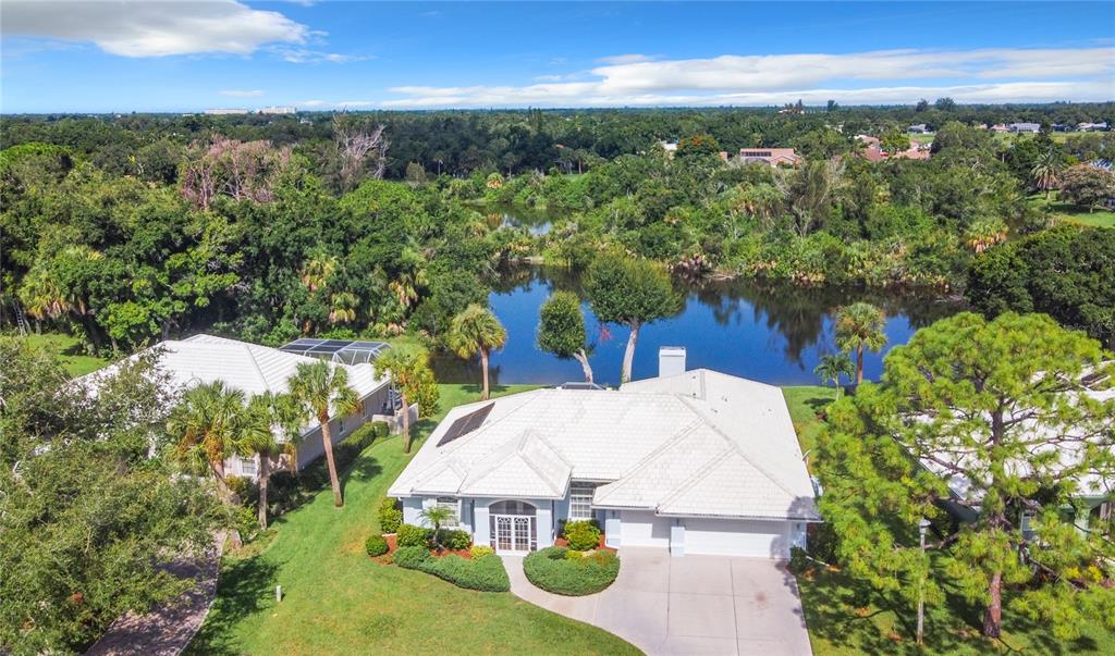 an aerial view of a house with yard swimming pool and outdoor seating