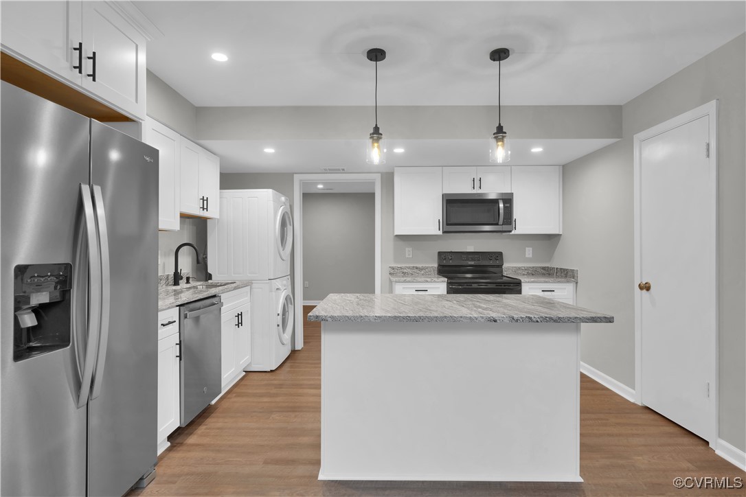 Kitchen with white cabinets, hanging light fixture