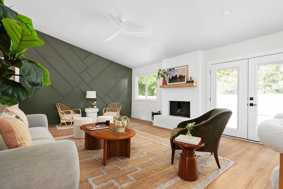 a living room with furniture a fireplace and a potted plant