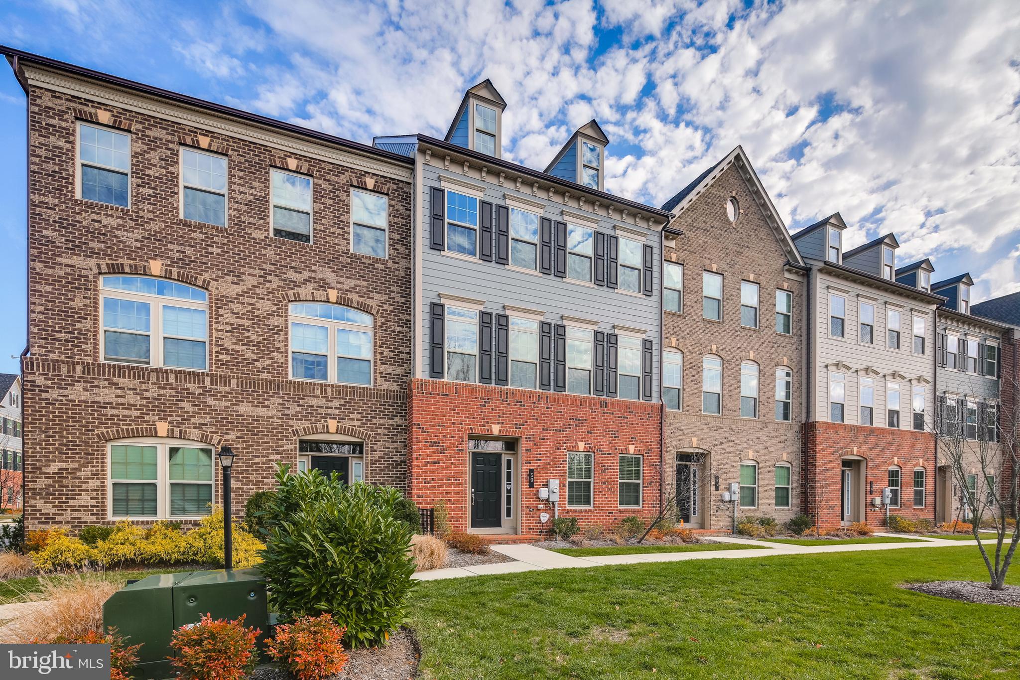 a large brick building with a yard in front of it