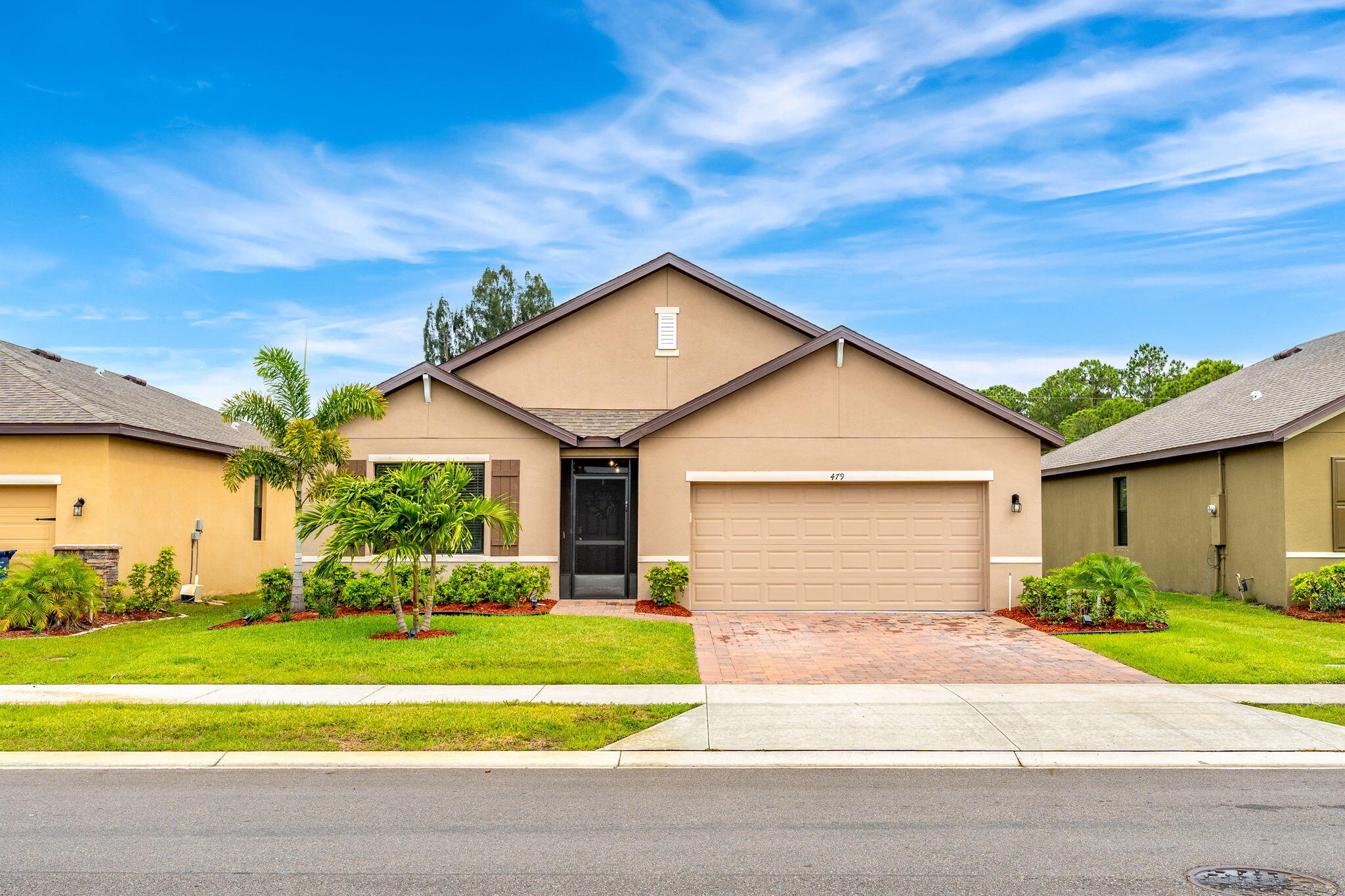 a front view of a house with a yard and garage