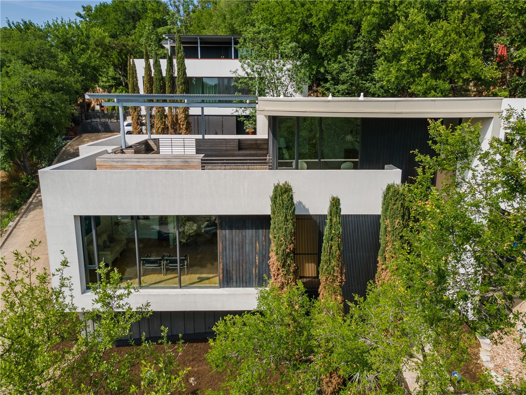 front view of house with a yard and potted plants