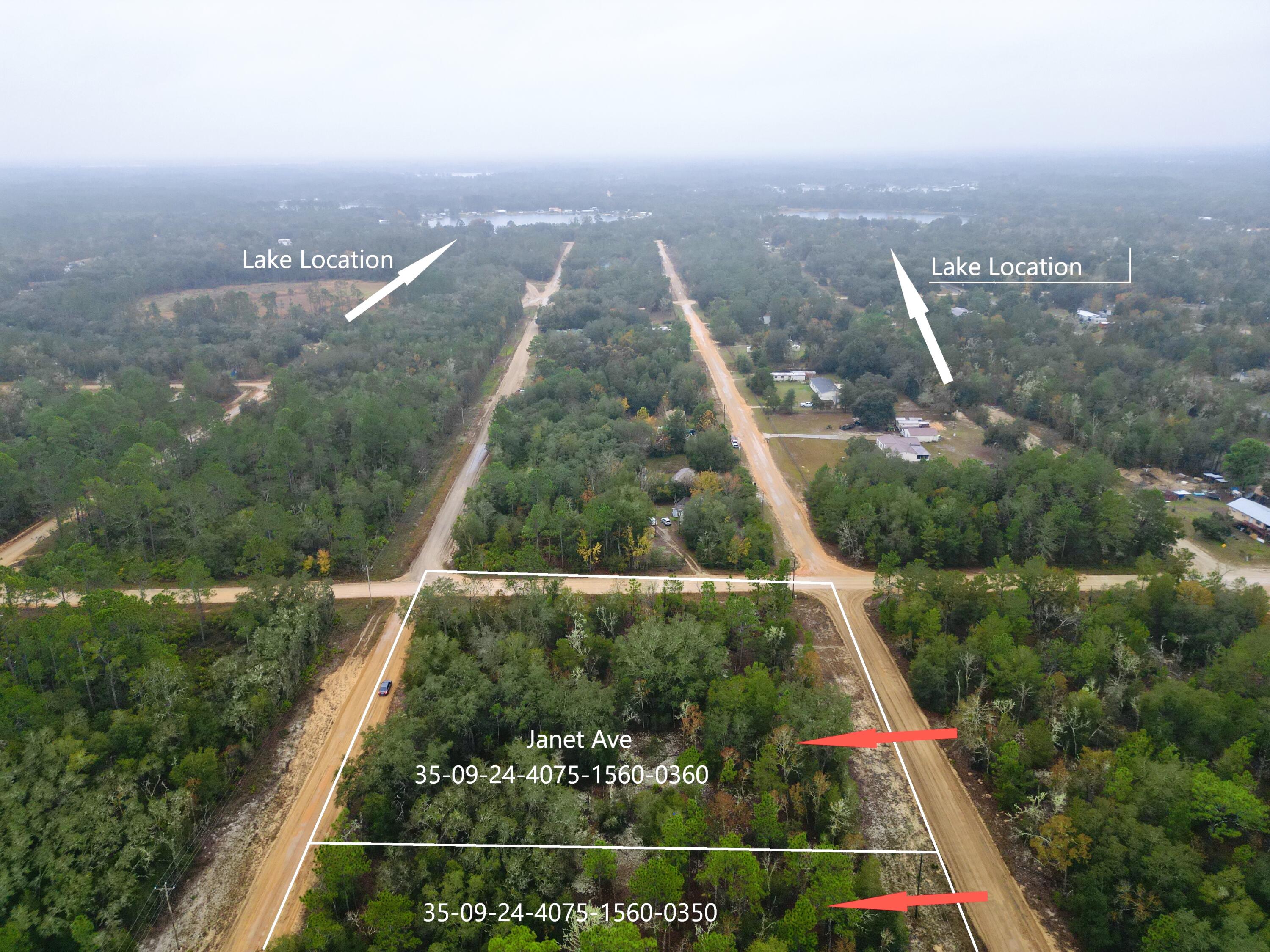 an aerial view of residential houses with outdoor space and street view