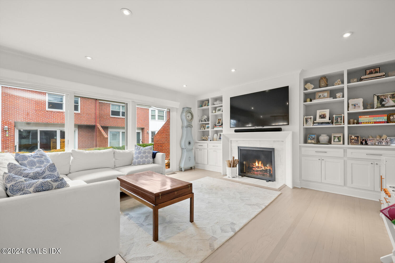 a living room with furniture a fireplace and a flat screen tv