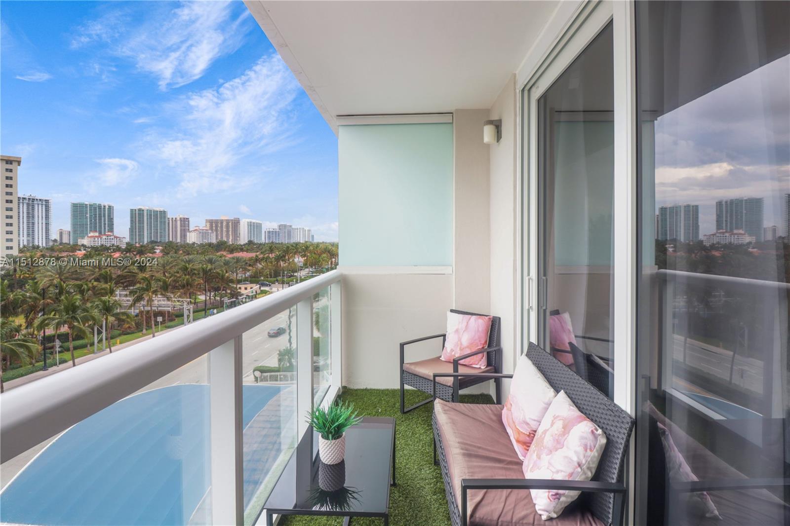 a balcony with wooden floor and furniture