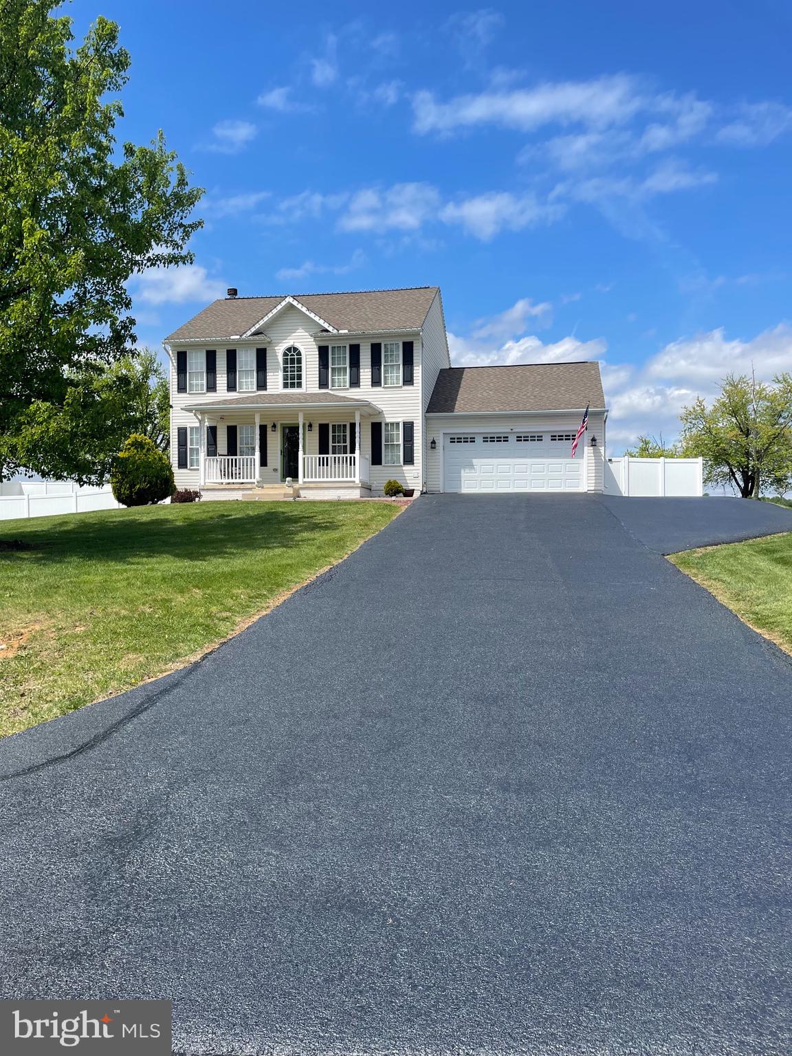 a view of house with yard and ocean view