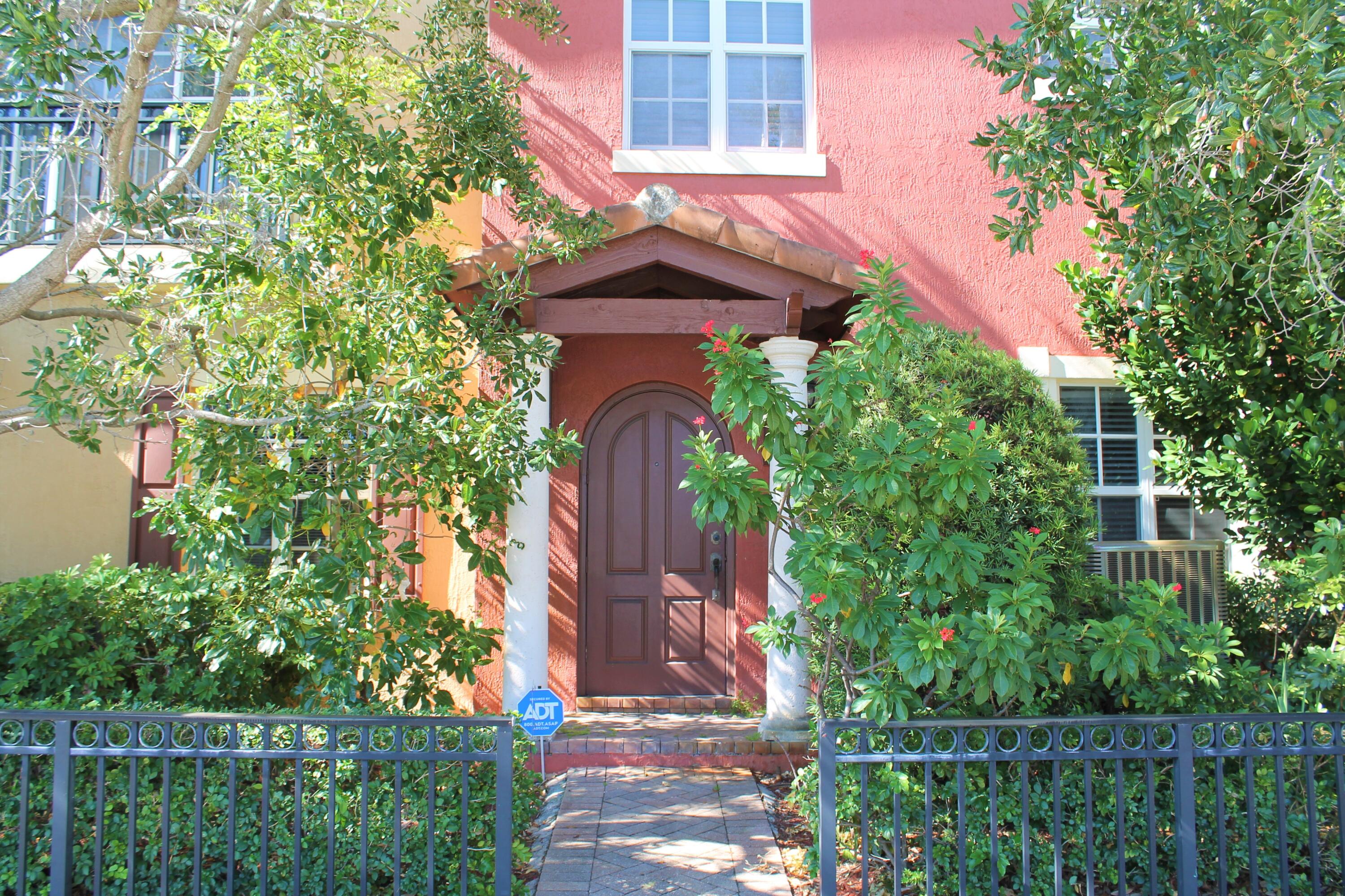 a red brick house with trees in front of it