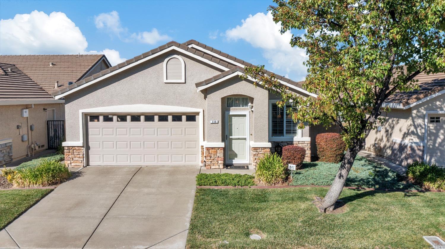 a front view of a house with a yard and garage