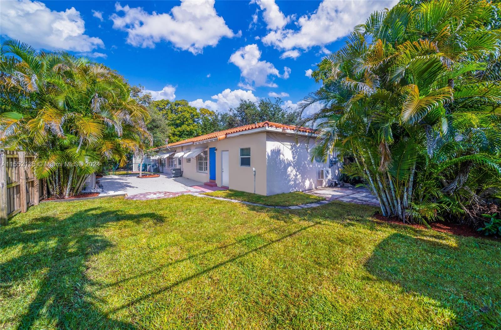 a view of a house with a backyard