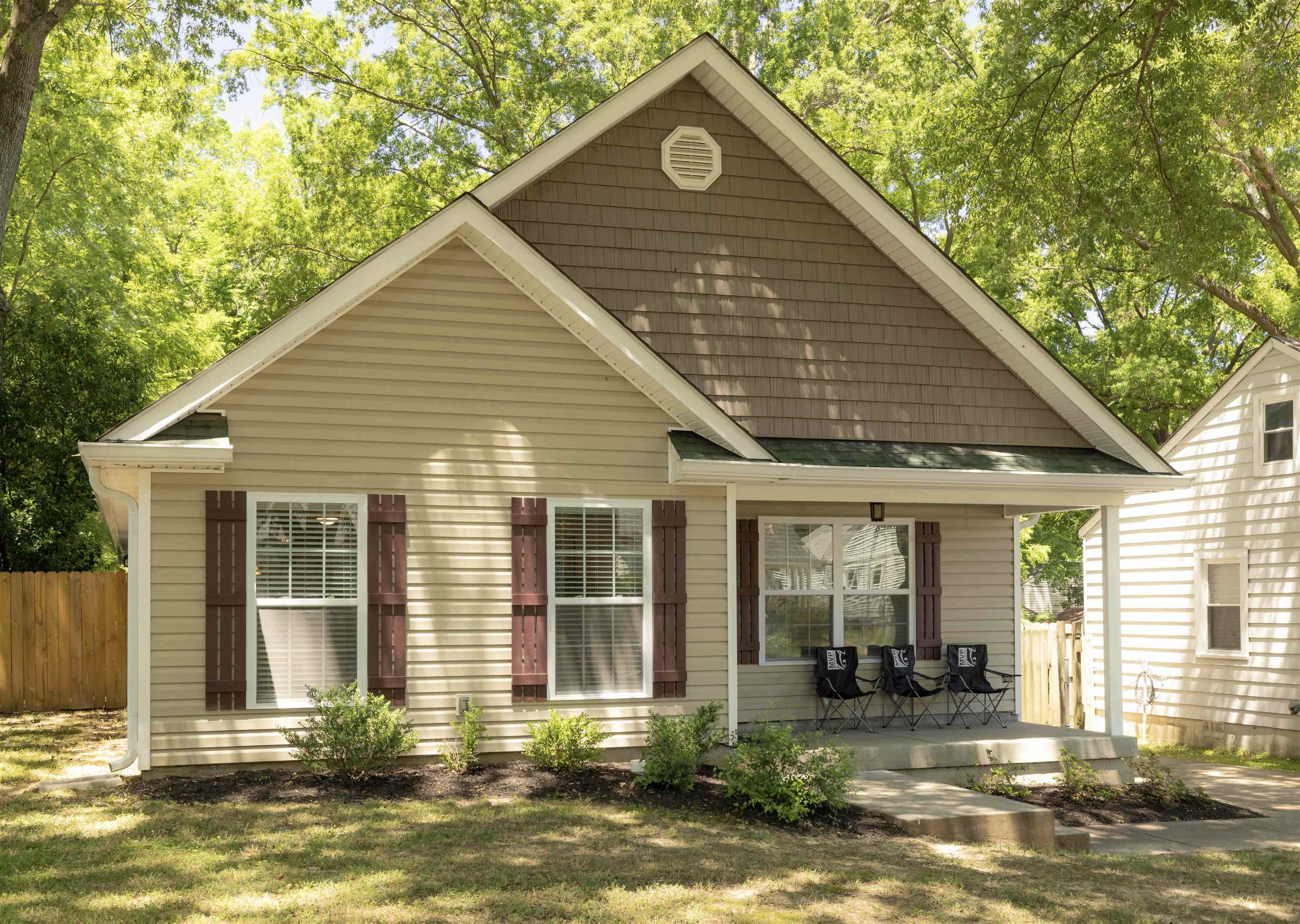 Front view of house featuring a yard and covered porch