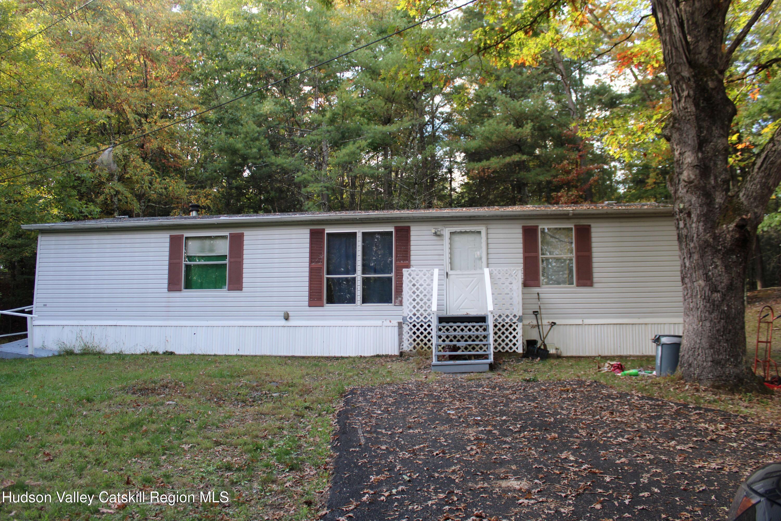 a view of house with backyard