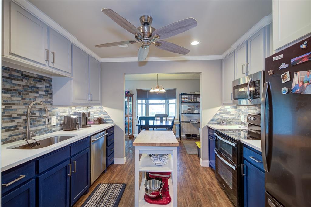 a kitchen with granite countertop a stove oven and cabinets