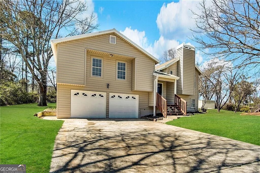 a front view of a house with a yard and garage