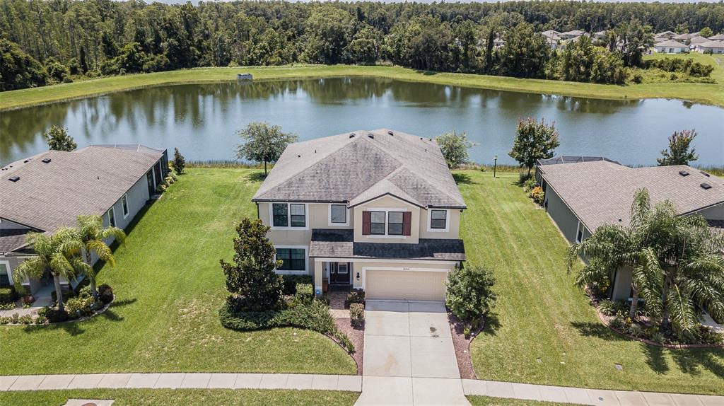 an aerial view of a house with a lake view