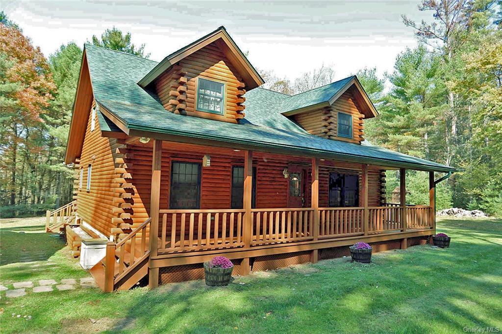 a view of a house with a yard and deck