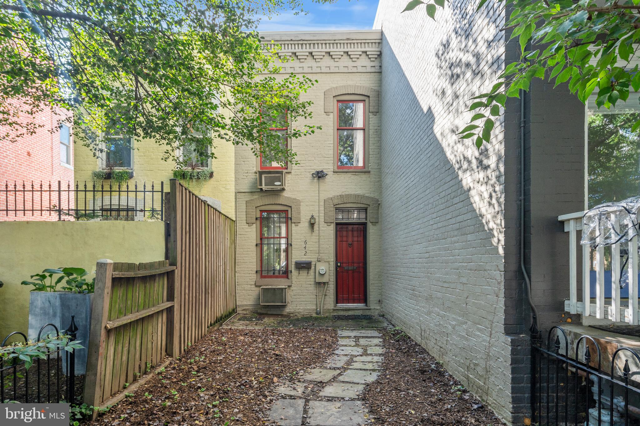 a view of a pathway with a house in the background