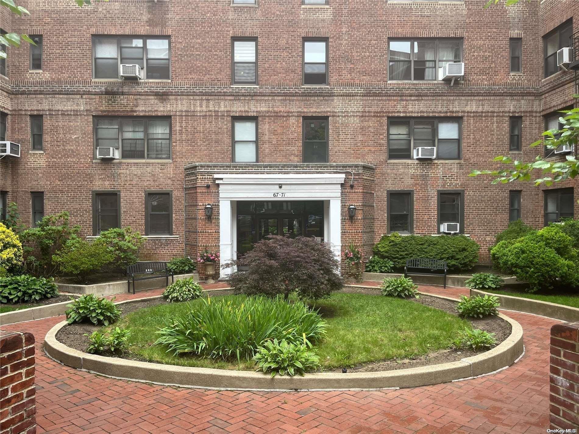 a view of a house with a small yard and plants