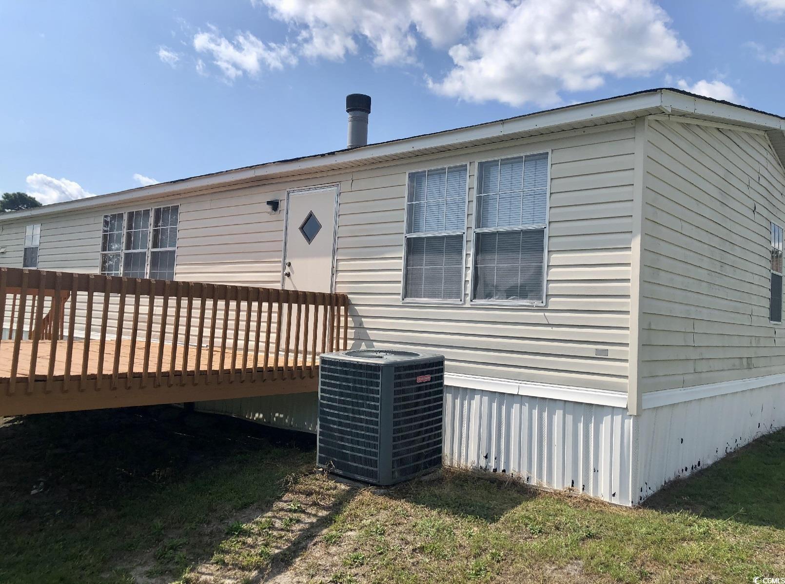 Rear view of property featuring a deck and central