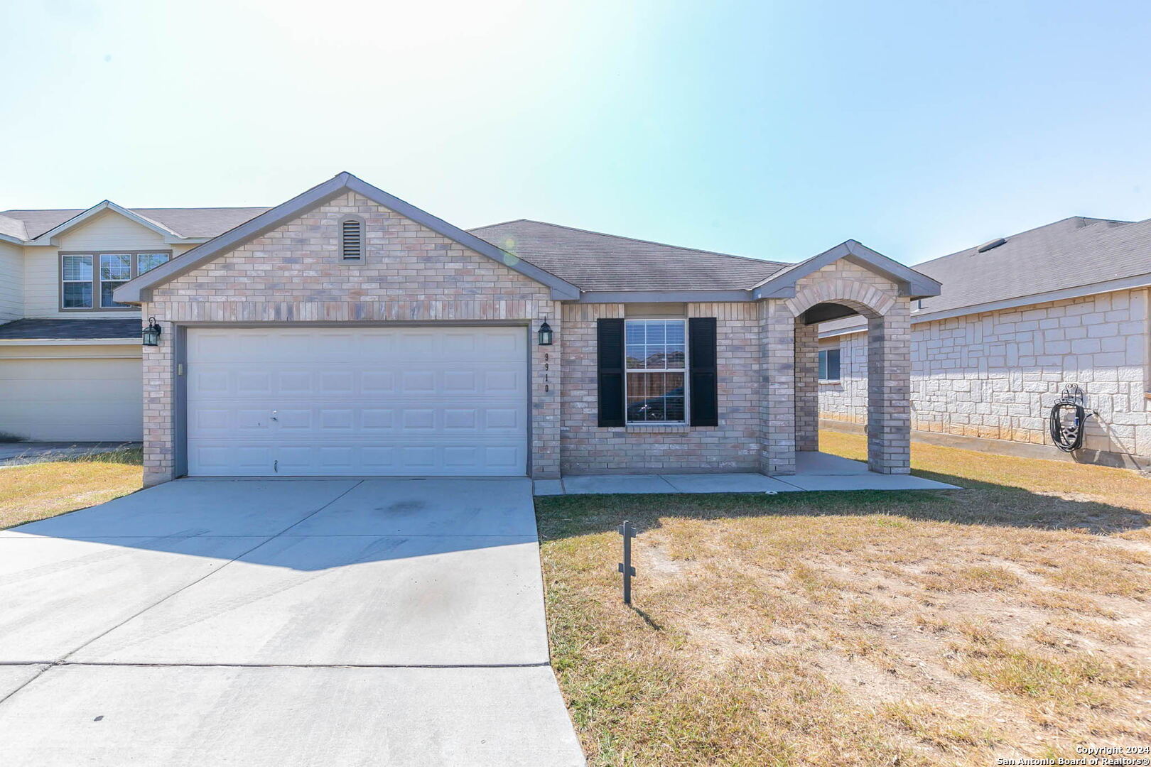 a front view of a house with a yard and garage