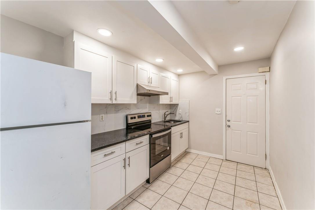 a kitchen with stainless steel appliances a refrigerator sink and cabinets