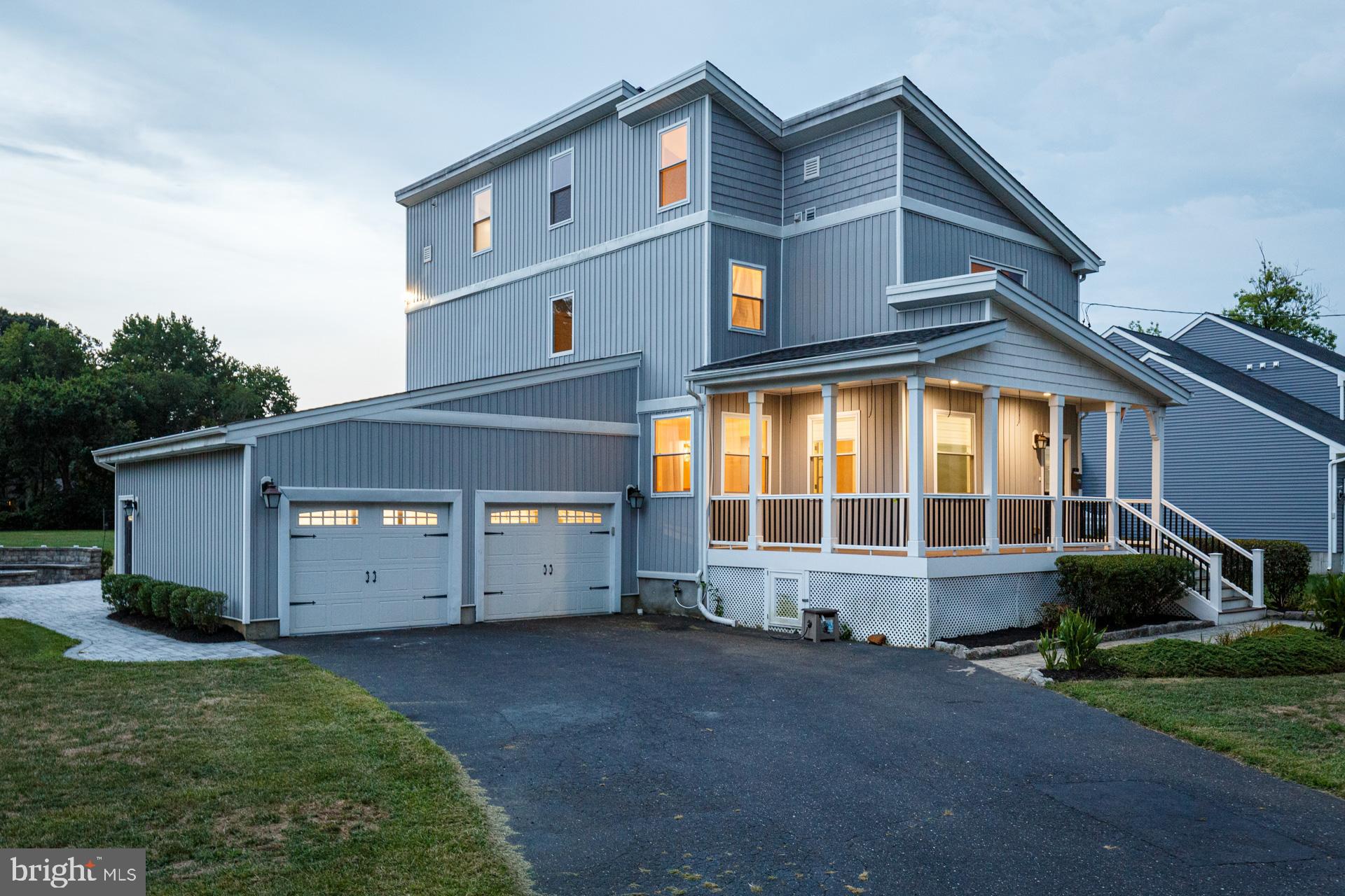 a view of a house with a yard and a garage